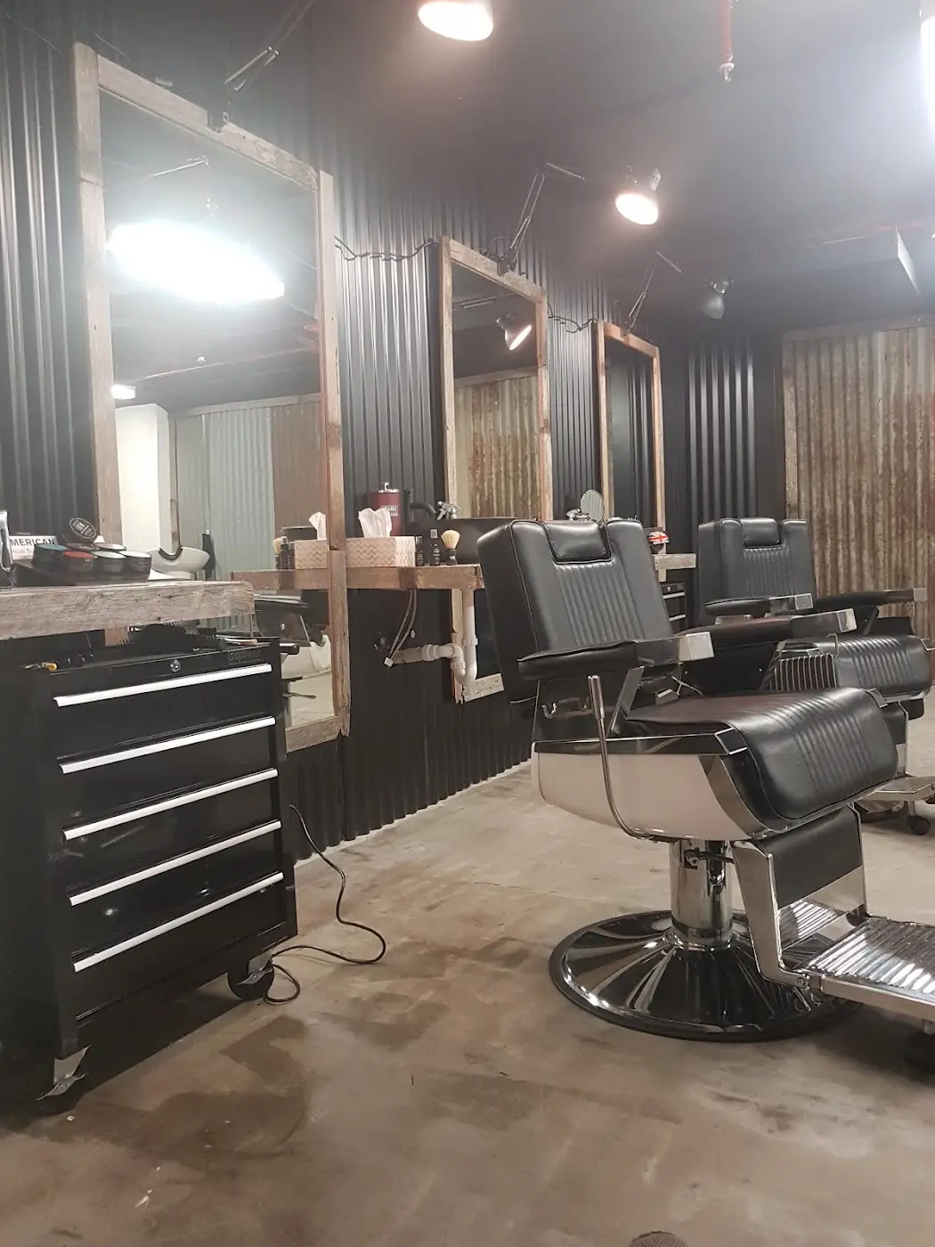 Inside Barberiko: barber chairs in a spacious, rustic room